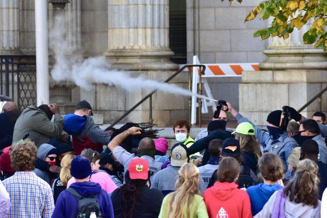 A spray of pepper floating above the heads of protesters