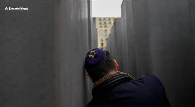 A man leaning against a wall. We see his back.