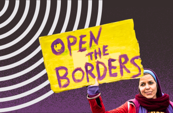 A woman holding a sign that says Open the Borders