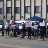 A group of people in Chicago holding protest signs