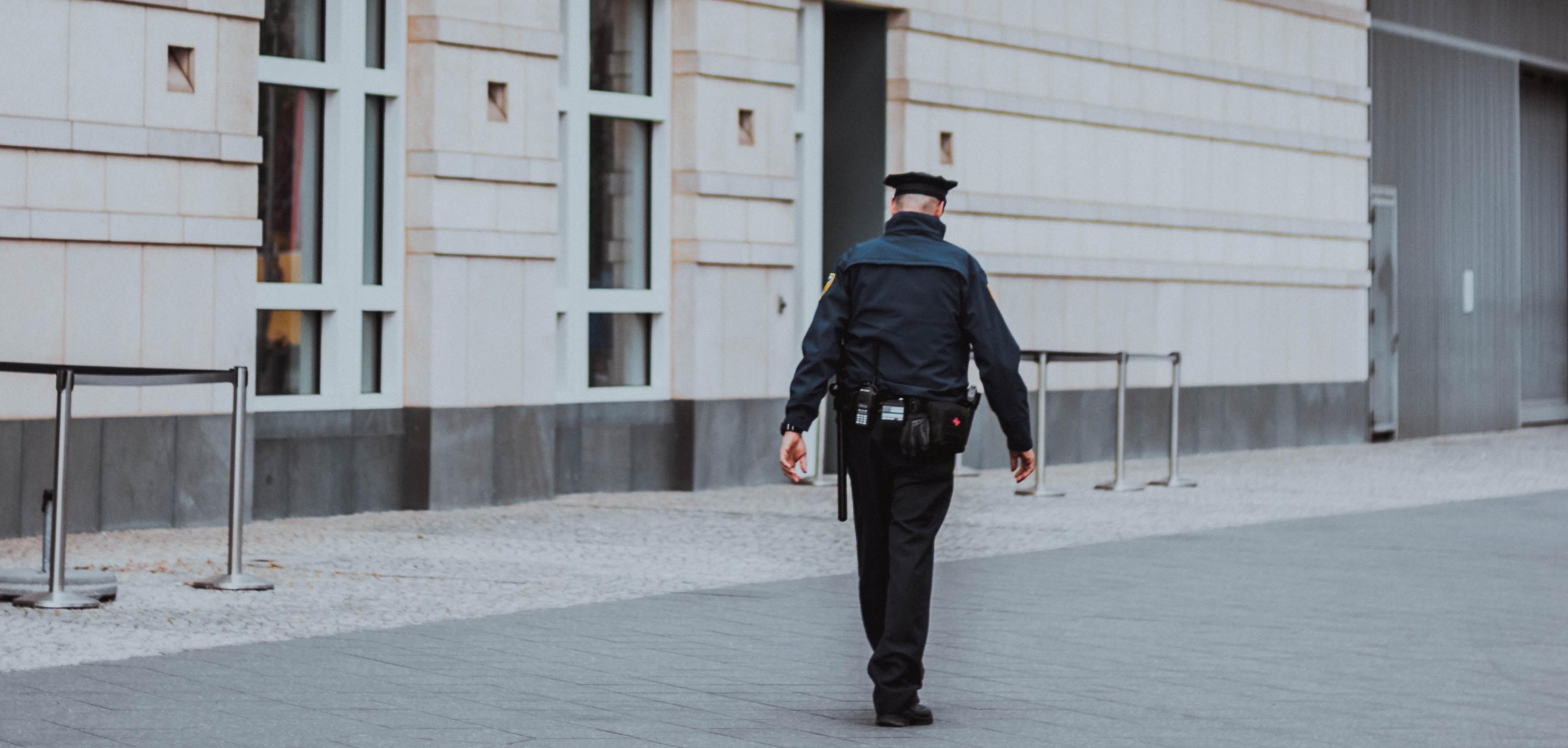 Police officer walking in empty street