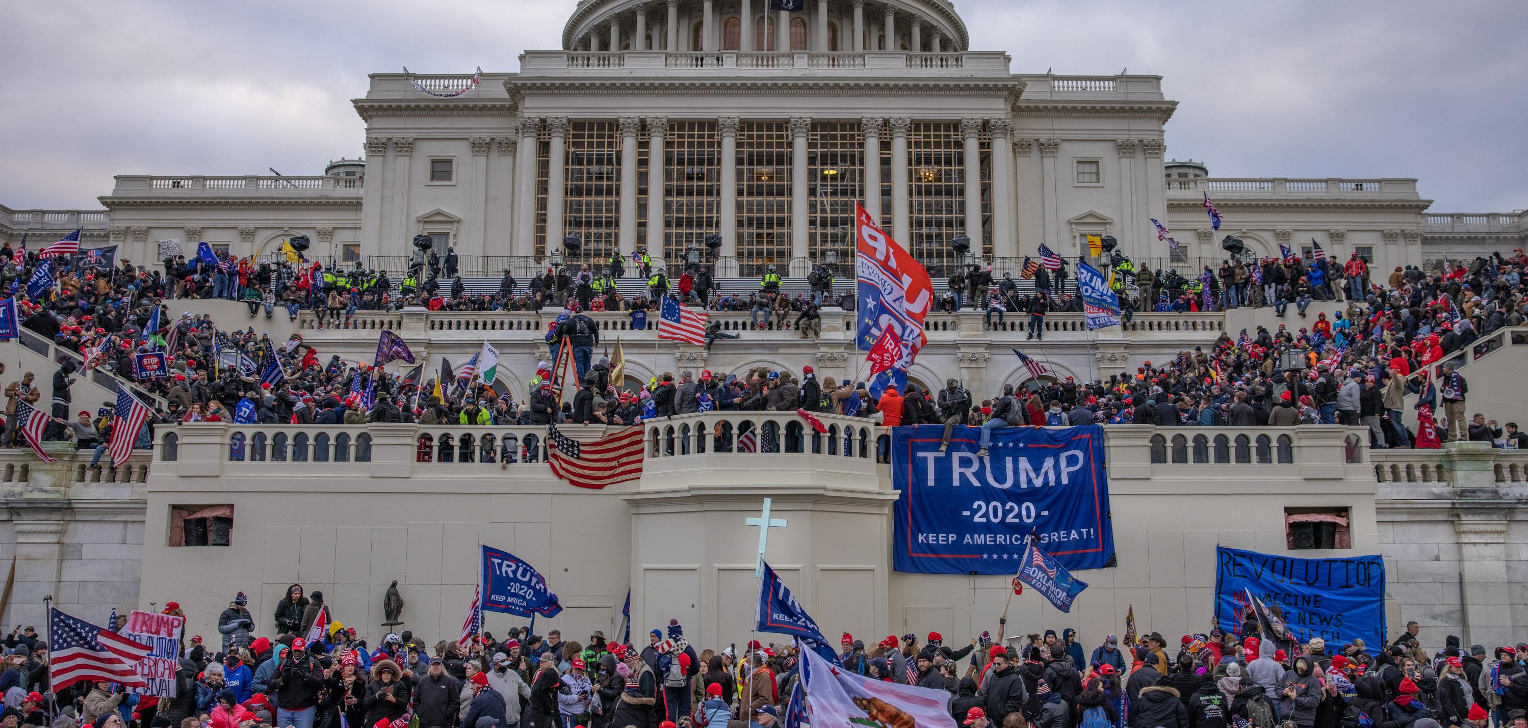 The Capitol building in D.C and Trump supporters all over it.