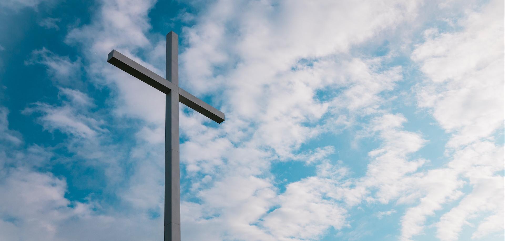 A cross with the sky in the background