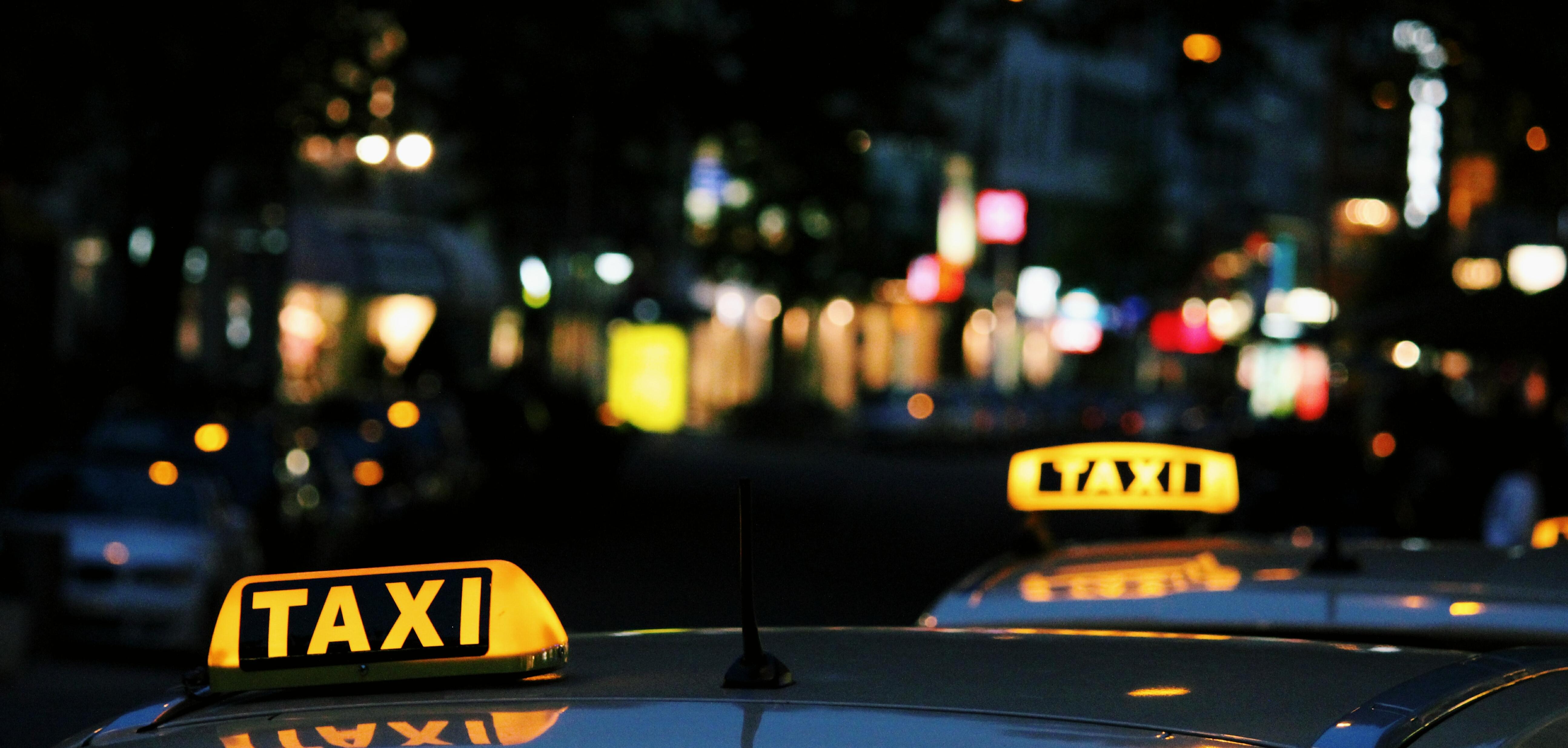 shallow focus photography of Taxi signage