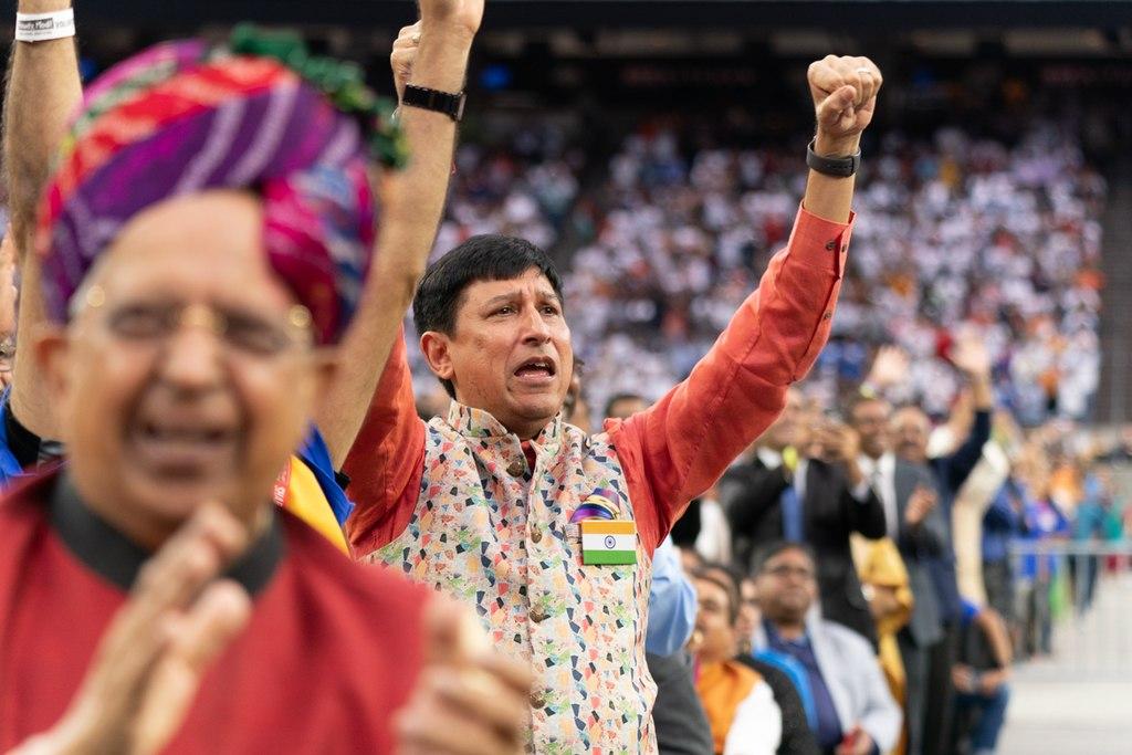 Group of people cheering with their arms in the air